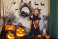 girl reads book spells. Halloween blonde witch. Magic wand in hands of magician.