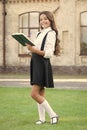 Girl ready for school. Happy girl back to school. Cute little girl smile with book outdoor. Adorable small girl with Royalty Free Stock Photo