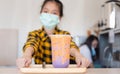 Girl ready to give boba tea service at the modern shop, Little girl learning serving, education concept