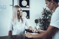 Girl at Reception of Modern Beauty Clinic with Client.