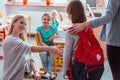 Girl with a red backpack says hello to her friends from school