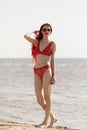 Girl in a red bathing suit on the beach Royalty Free Stock Photo