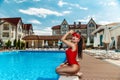 Girl in a red bathing suit near the pool Royalty Free Stock Photo
