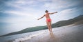 the girl in the red bathing suit spinning on the beach Royalty Free Stock Photo