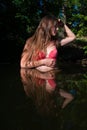 Girl in red bikini in dark water Royalty Free Stock Photo