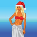 Girl in a red bikini and a santa hat on the beach Royalty Free Stock Photo