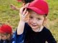 Girl with red cap is smiling to camera Royalty Free Stock Photo