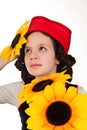 Girl in a red cap with a sunflower Royalty Free Stock Photo