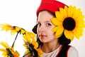 Girl in a red cap with a sunflower Royalty Free Stock Photo