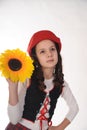 Girl in a red cap with a sunflower Royalty Free Stock Photo