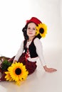 Girl in a red cap with a sunflower Royalty Free Stock Photo