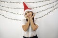 Girl with a red christmas hat and red hair, with her hands on her face very happy Royalty Free Stock Photo