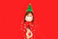 Girl in a red Christmas sweater during the quarantine period