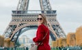 Girl in red coat and bag at parisian street Royalty Free Stock Photo