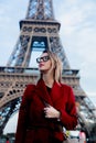 Girl in red coat and bag at parisian street Royalty Free Stock Photo