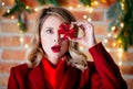 Girl in red coat with gift box at Christmas lights background Royalty Free Stock Photo