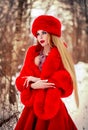 Girl in red dress in winter forest