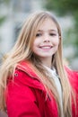 Girl in red coat sit on bench in park Royalty Free Stock Photo