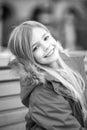 Girl in red coat sit on bench in park Royalty Free Stock Photo