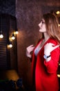 Girl in red costume near mirrow in the dark room Royalty Free Stock Photo