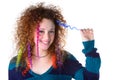 Girl with red curly hair holding a lock of colored hair