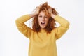 Girl with red curly messy hair, tousle hairstyle and making daring, sassy expression, enjoying her new color, change Royalty Free Stock Photo