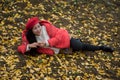 The girl in red overlie with ginkgo leaf Royalty Free Stock Photo