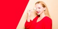 Girl in a red dress on a beige background. A woman eats with chopsticks for sushi, closes her eyes with them and grimaces, smiles Royalty Free Stock Photo