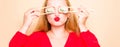 Girl in a red dress on a beige background. A woman eats with chopsticks for sushi, closes her eyes with them and grimaces, smiles Royalty Free Stock Photo