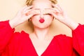 Girl in a red dress on a beige background. A woman eats with chopsticks for sushi, closes her eyes with them and grimaces, smiles Royalty Free Stock Photo