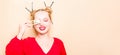 Girl in a red dress on a beige background. A woman eats with chopsticks for sushi, closes her eyes with them and grimaces, smiles Royalty Free Stock Photo