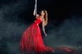 Girl red dress dances around a pole night mist. Royalty Free Stock Photo