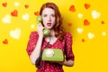 Girl in red dress with green dial phone and hearts Royalty Free Stock Photo