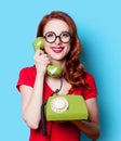 Girl in red dress with green dial phone Royalty Free Stock Photo