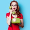 Girl in red dress with green dial phone Royalty Free Stock Photo