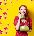 Girl in red dress with green dial phone Royalty Free Stock Photo