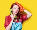 Girl in red dress with green dial phone Royalty Free Stock Photo