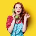 Girl in red dress with green dial phone Royalty Free Stock Photo