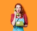 Girl in red dress with green dial phone Royalty Free Stock Photo