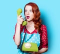 Girl in red dress with green dial phone Royalty Free Stock Photo