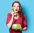 Girl in red dress with green dial phone Royalty Free Stock Photo