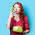 Girl in red dress with green dial phone Royalty Free Stock Photo