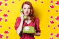 Girl in red dress with green dial phone Royalty Free Stock Photo