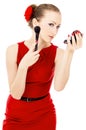 The girl in the red dress, imposes a make-up Royalty Free Stock Photo