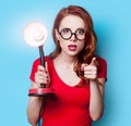 Girl in red dress with lamp Royalty Free Stock Photo