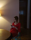 Girl in red dress looking at her phone