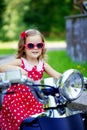 Girl in a red dress on a motorcycle Royalty Free Stock Photo