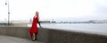 Girl in a red dress on the Palace embankment in St. Petersburg Royalty Free Stock Photo