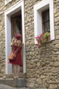 Girl in red dress taking picture in village of Ainsa, Spain Royalty Free Stock Photo