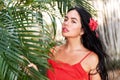 girl in a red dress among tropical palm trees in Thailand at sunset Royalty Free Stock Photo